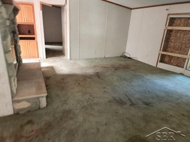 2502 Lynnwood Ave, Saginaw, MI 48601 - empty room featuring carpet, ornamental molding, and a decorative wall