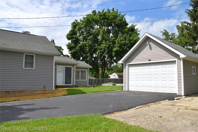 116 Park St, Gaines, MI 48436 - view of front facade with a garage, an outdoor structure, and a shingled roof