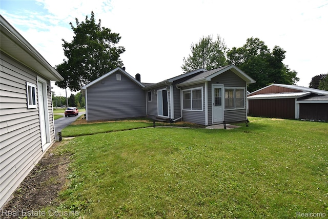 116 Park St, Gaines, MI 48436 - back of house with a yard and a chimney