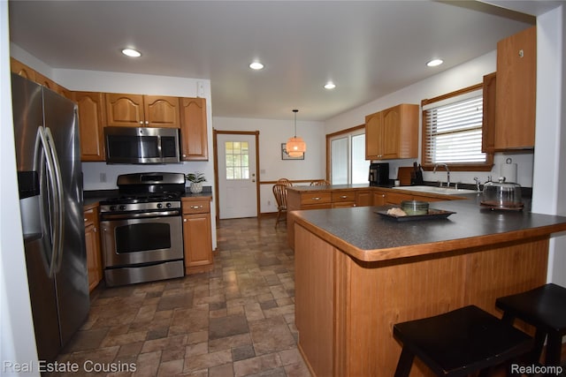 116 Park St, Gaines, MI 48436 - kitchen with stainless steel appliances, a peninsula, dark countertops, dark stone finish flooring, and recessed lighting