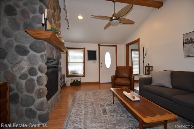 116 Park St, Gaines, MI 48436 - living room with a stone fireplace, ceiling fan, and light wood-type flooring