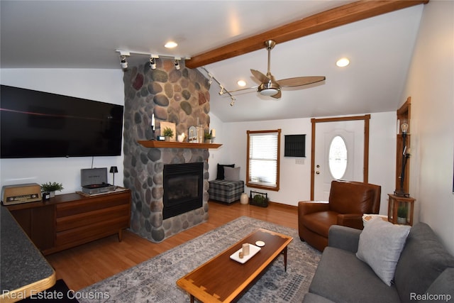 116 Park St, Gaines, MI 48436 - living area with wood finished floors, ceiling fan, and a fireplace