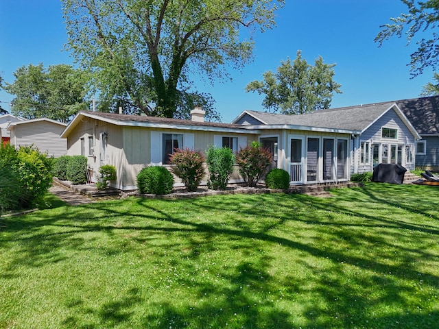 31467 Maple Island Rd, Dowagiac, MI 49047 - view of front facade with a front yard, a chimney, and a sunroom