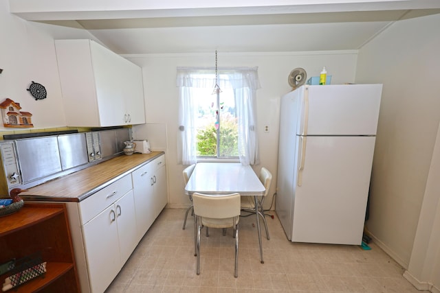 31467 Maple Island Rd, Dowagiac, MI 49047 - kitchen with freestanding refrigerator, white cabinetry, light countertops, and light floors