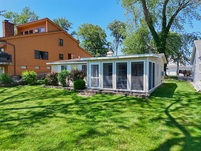 31467 Maple Island Rd, Dowagiac, MI 49047 - rear view of property with a sunroom, a chimney, and a lawn