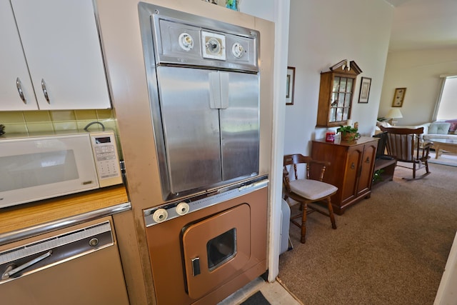 31467 Maple Island Rd, Dowagiac, MI 49047 - kitchen with white microwave, carpet floors, dishwasher, backsplash, and wall oven