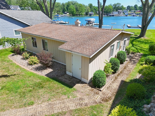 31467 Maple Island Rd, Dowagiac, MI 49047 - view of side of property with a shingled roof, a water view, and a yard