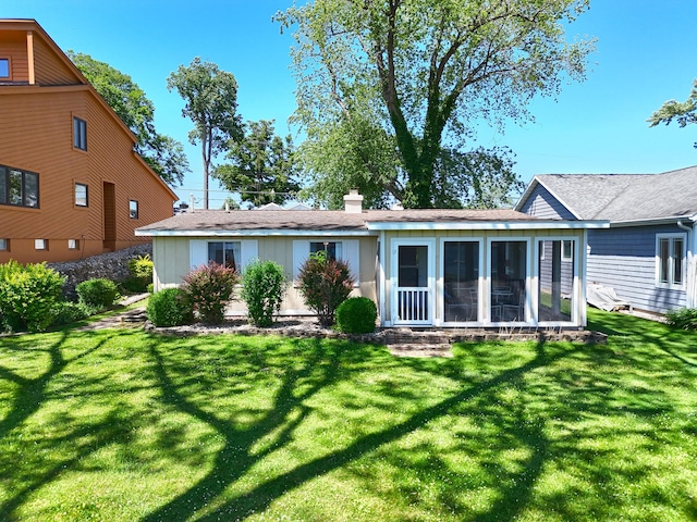 31467 Maple Island Rd, Dowagiac, MI 49047 - rear view of house featuring a yard, a sunroom, and a chimney