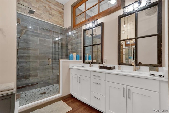 127 S Union St, Traverse City, MI 49684 - full bathroom featuring double vanity, a stall shower, and wood finished floors