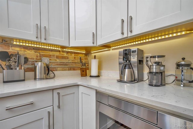 127 S Union St, Traverse City, MI 49684 - kitchen view of white cabinets and light stone countertops