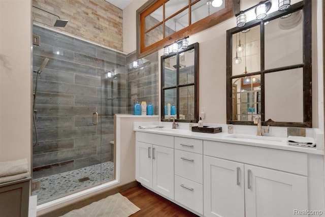 127 S Union St, Traverse City, MI 49684 - bathroom featuring a shower stall, double vanity, and wood finished floors