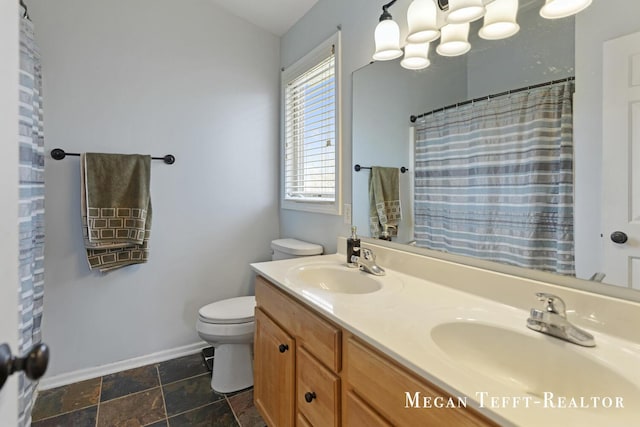 6641 Laguna Vista Dr NE, Rockford, MI 49341 - full bathroom featuring double vanity, stone finish floors, and a shower with shower curtain