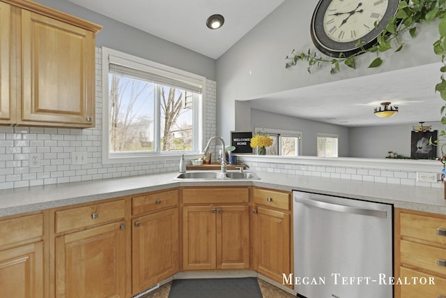 6641 Laguna Vista Dr NE, Rockford, MI 49341 - kitchen with stainless steel dishwasher, decorative backsplash, light countertops, and lofted ceiling