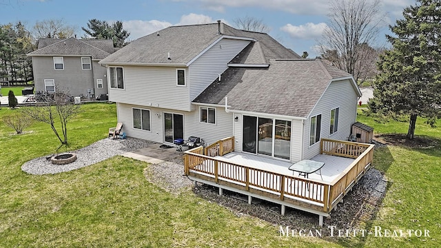 6641 Laguna Vista Dr NE, Rockford, MI 49341 - back of house with an outdoor fire pit, a yard, a wooden deck, and a shingled roof