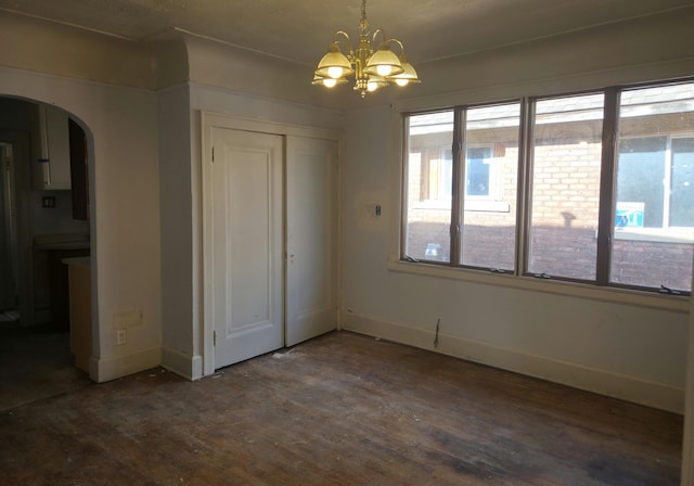 3742 W Grand St, Detroit, MI 48238 - unfurnished dining area with arched walkways, a chandelier, and wood finished floors