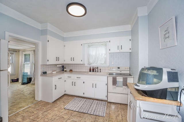 1118 Sibley St NW, Grand Rapids, MI 49504 - kitchen featuring white electric stove, crown molding, backsplash, light countertops, and white cabinets
