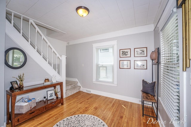 1118 Sibley St NW, Grand Rapids, MI 49504 - sitting room featuring light wood-style floors, stairway, and crown molding