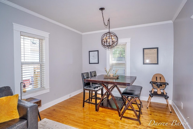 1118 Sibley St NW, Grand Rapids, MI 49504 - dining space with a chandelier, ornamental molding, and light wood-style floors