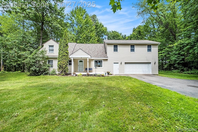 15375 Murray Rd, Byron, MI 48418 - view of front of property with a garage, asphalt driveway, and a front lawn