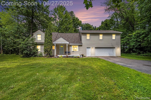 15375 Murray Rd, Byron, MI 48418 - view of front of property featuring an attached garage, driveway, a front yard, and a porch