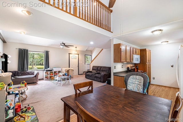 15375 Murray Rd, Byron, MI 48418 - dining area featuring ceiling fan, stairs, and light wood-style flooring