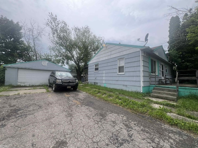 1297 W Kurtz Ave, Flint, MI 48505 - view of property exterior featuring a detached garage and an outdoor structure