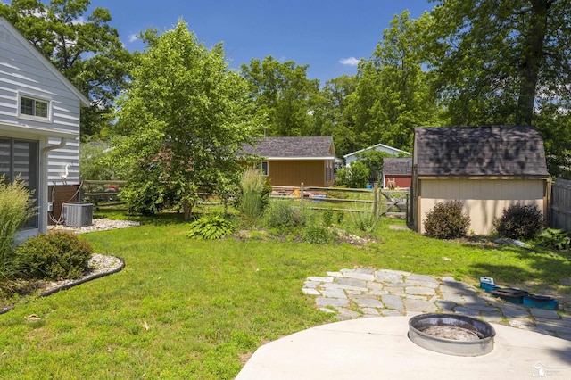 7558 Indian Rd, Temperance, MI 48182 - fenced backyard with a storage shed, a patio area, and a fire pit