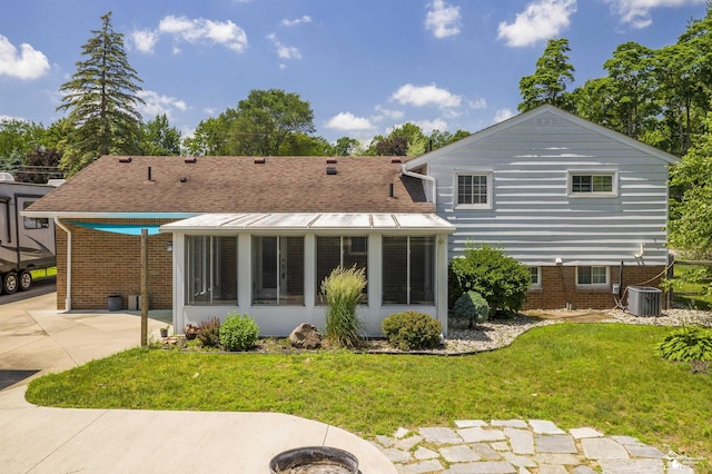 7558 Indian Rd, Temperance, MI 48182 - back of property with a sunroom and a lawn