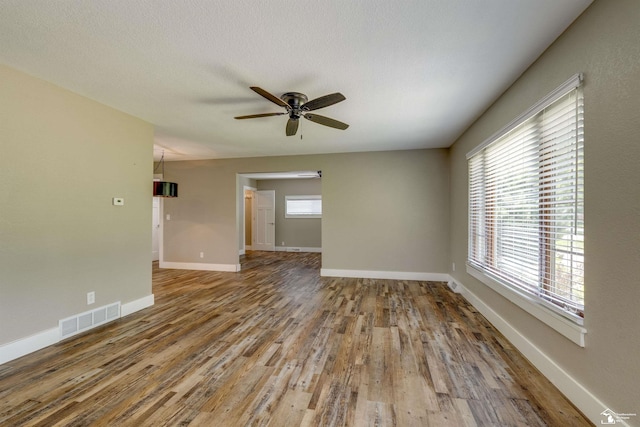 7558 Indian Rd, Temperance, MI 48182 - spare room featuring ceiling fan, wood finished floors, and plenty of natural light