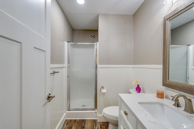 7558 Indian Rd, Temperance, MI 48182 - full bathroom featuring a shower stall, vanity, a wainscoted wall, and wood finished floors
