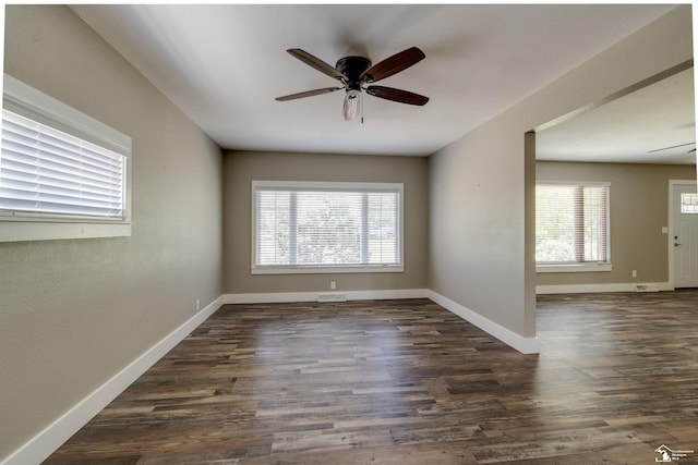 7558 Indian Rd, Temperance, MI 48182 - spare room featuring plenty of natural light, a ceiling fan, and dark wood finished floors