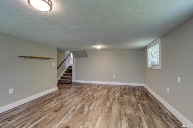 7558 Indian Rd, Temperance, MI 48182 - below grade area with wood finished floors, stairway, and a textured ceiling