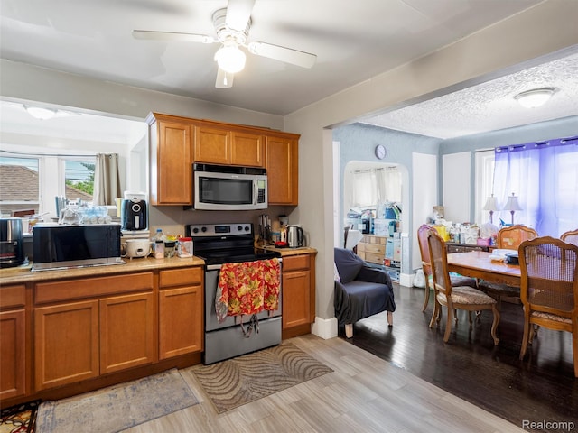 7420 Coolidge, Center Line, MI 48015 - kitchen featuring appliances with stainless steel finishes, brown cabinetry, light countertops, and ceiling fan