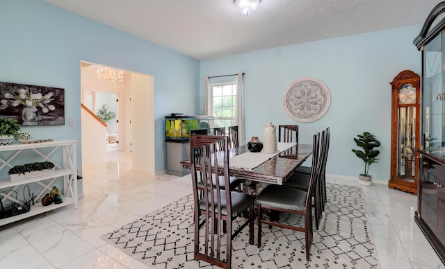 10895 Riley St, Zeeland, MI 49464 - dining room with a chandelier and light marble finish floors