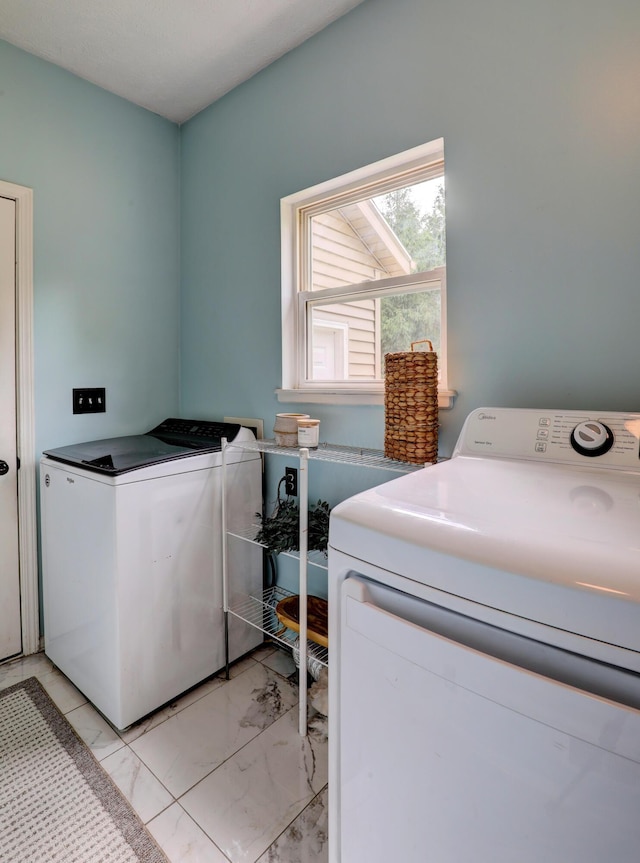 10895 Riley St, Zeeland, MI 49464 - laundry room featuring washing machine and dryer and light marble finish flooring