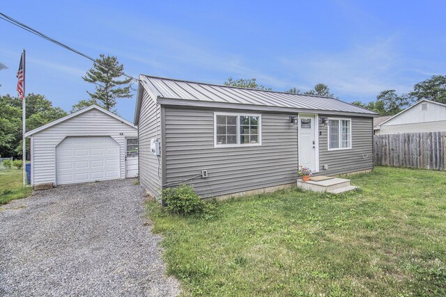 1118 Huntly Rd, Niles, MI 49120 - bungalow-style house with an outbuilding, a garage, gravel driveway, and a metal roof