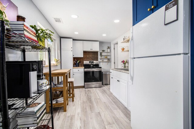1118 Huntly Rd, Niles, MI 49120 - kitchen with appliances with stainless steel finishes, open shelves, white cabinetry, light wood-style floors, and light countertops
