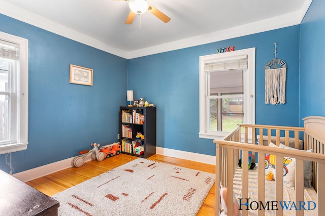 660 Deming St SE, Grand Rapids, MI 49507 - bedroom with wood finished floors and a crib