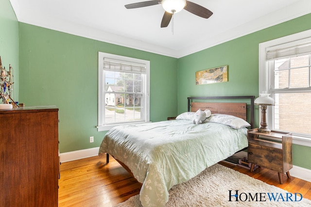 660 Deming St SE, Grand Rapids, MI 49507 - bedroom featuring wood finished floors, multiple windows, ceiling fan, and crown molding
