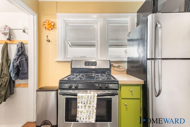 660 Deming St SE, Grand Rapids, MI 49507 - kitchen with stainless steel appliances, green cabinets, and light countertops