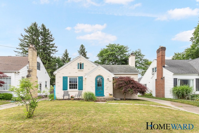 660 Deming St SE, Grand Rapids, MI 49507 - view of front of house featuring a front lawn and brick siding