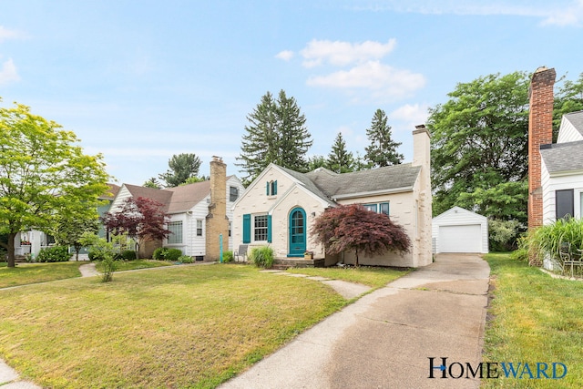 660 Deming St SE, Grand Rapids, MI 49507 - view of front of property featuring driveway, a detached garage, a front lawn, an outdoor structure, and a chimney