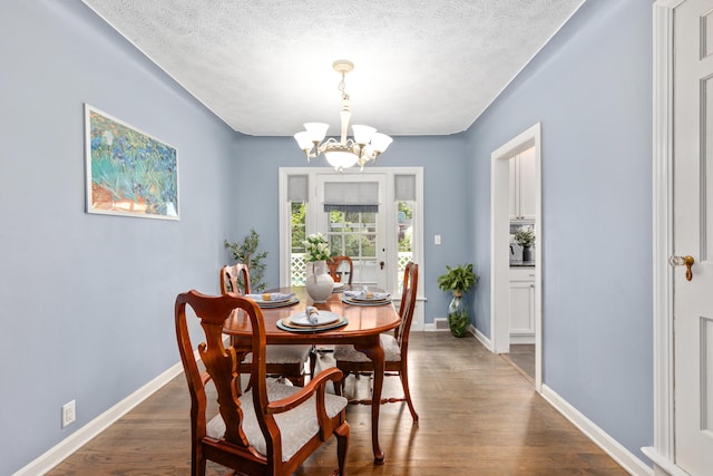 2013 Duiker Ave NE, Grand Rapids, MI 49505 - dining room with a chandelier, wood finished floors, and a textured ceiling