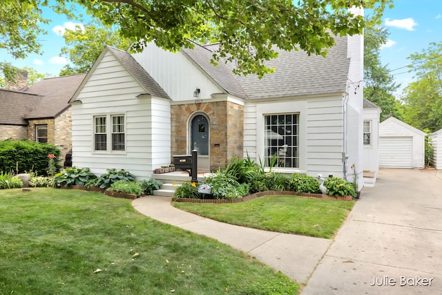 2013 Duiker Ave NE, Grand Rapids, MI 49505 - view of front facade featuring a shingled roof, an outdoor structure, a garage, and a front yard
