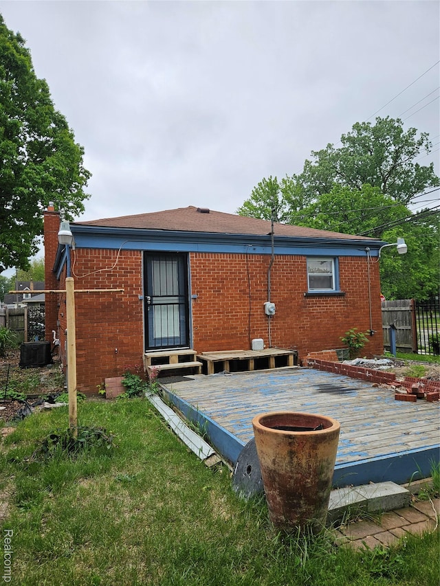 22638 Chippewa St, Detroit, MI 48219 - rear view of property with a deck, brick siding, and a chimney