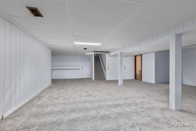 2155 Lake Michigan Dr NW, Grand Rapids, MI 49504 - finished below grade area with stairway, carpet flooring, wood walls, and a paneled ceiling
