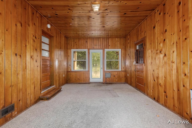 2155 Lake Michigan Dr NW, Grand Rapids, MI 49504 - carpeted spare room featuring wood ceiling and wood walls