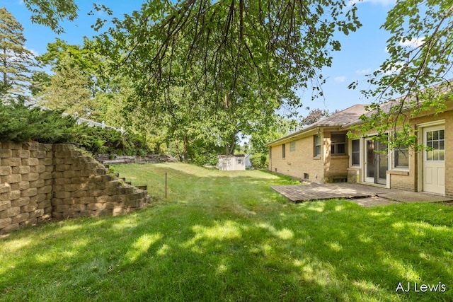 2155 Lake Michigan Dr NW, Grand Rapids, MI 49504 - view of green lawn with an outbuilding and a patio area