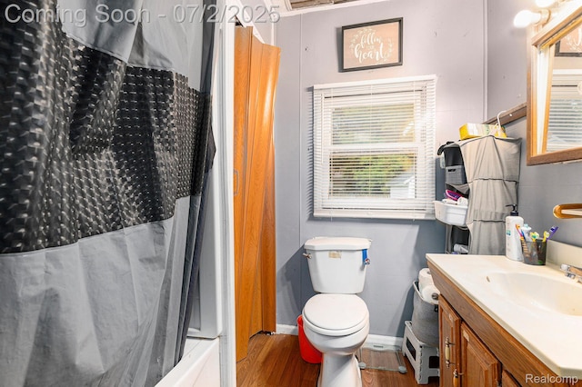 1323 Rhodes St, Jackson, MI 49202 - bathroom featuring wood finished floors, vanity, and shower / bath combination with curtain