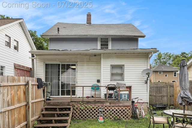 1323 Rhodes St, Jackson, MI 49202 - back of property featuring a wooden deck, a chimney, and outdoor dining area